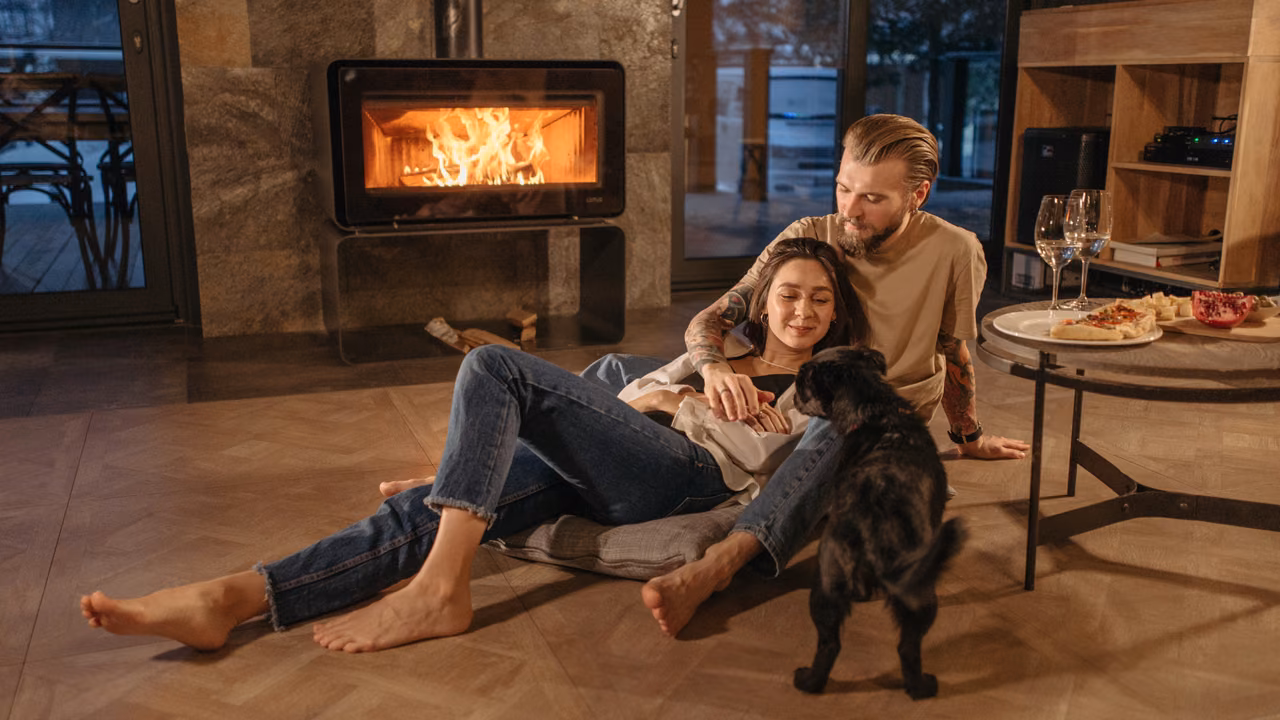 Couple relaxing by the fireplace with their black dog, ESA letter in Atlanta, GA