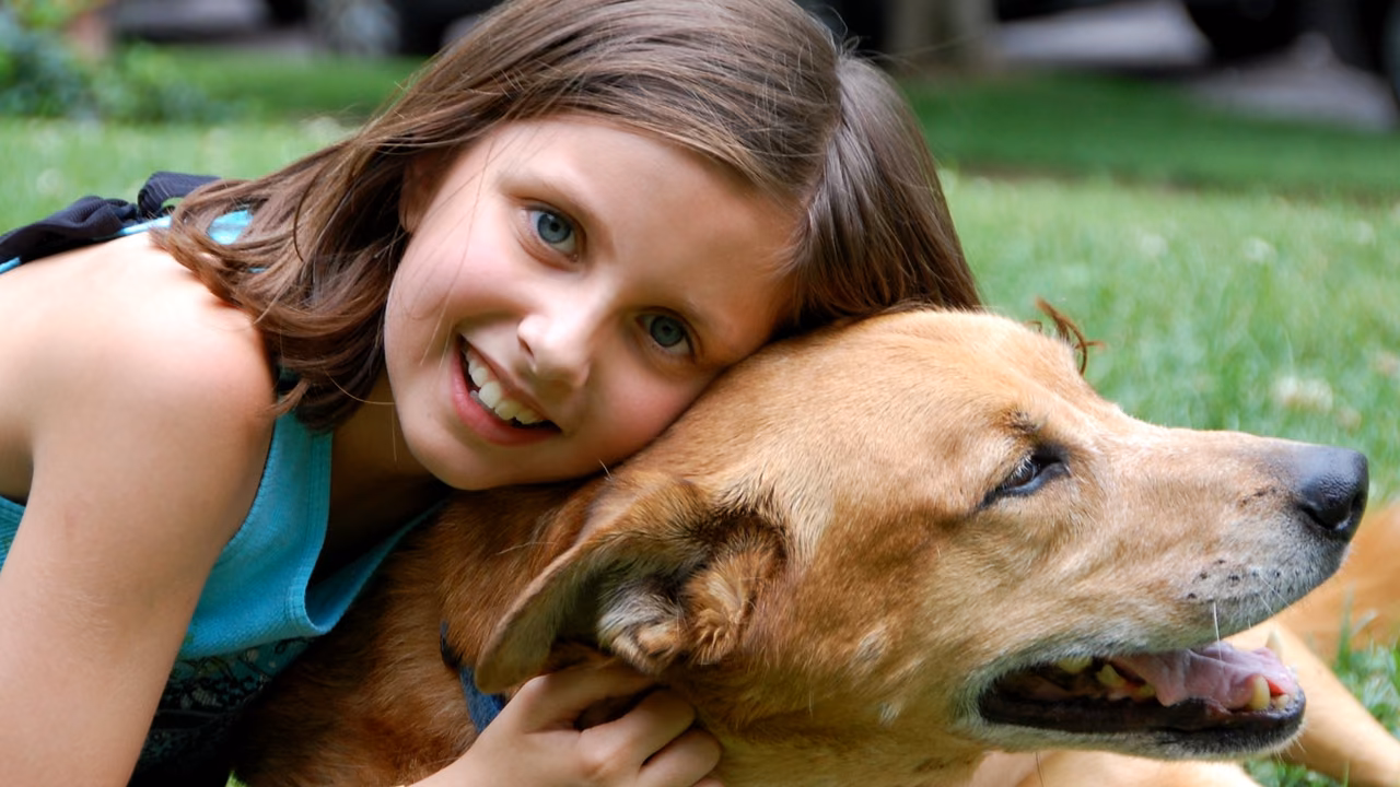 Girl hugging her dog on the grass, ESA letter in Baltimore, MD