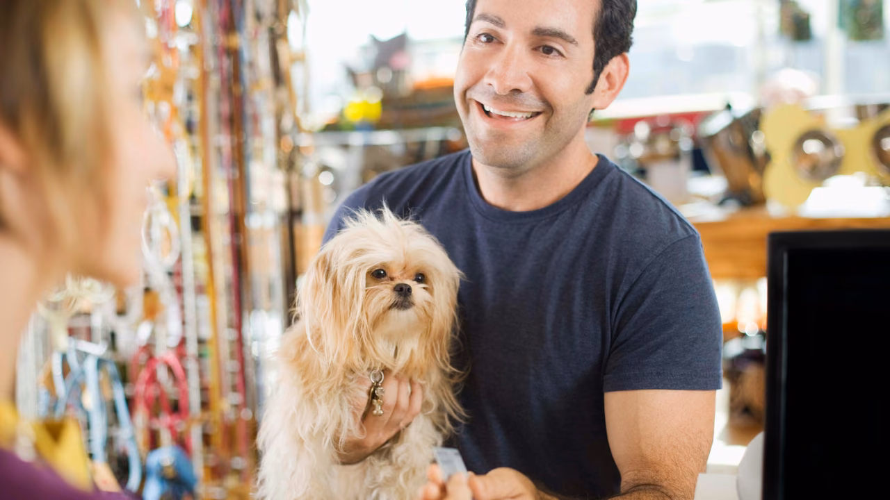 Man holding his small dog in a pet shop, ESA letter in Cincinnati, OH
