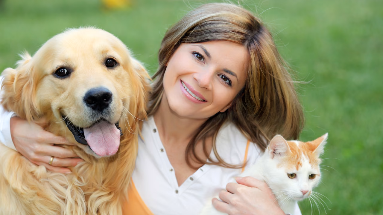 Woman hugging her golden retriever and her cat outdoors, ESA letter in Columbia, SC
