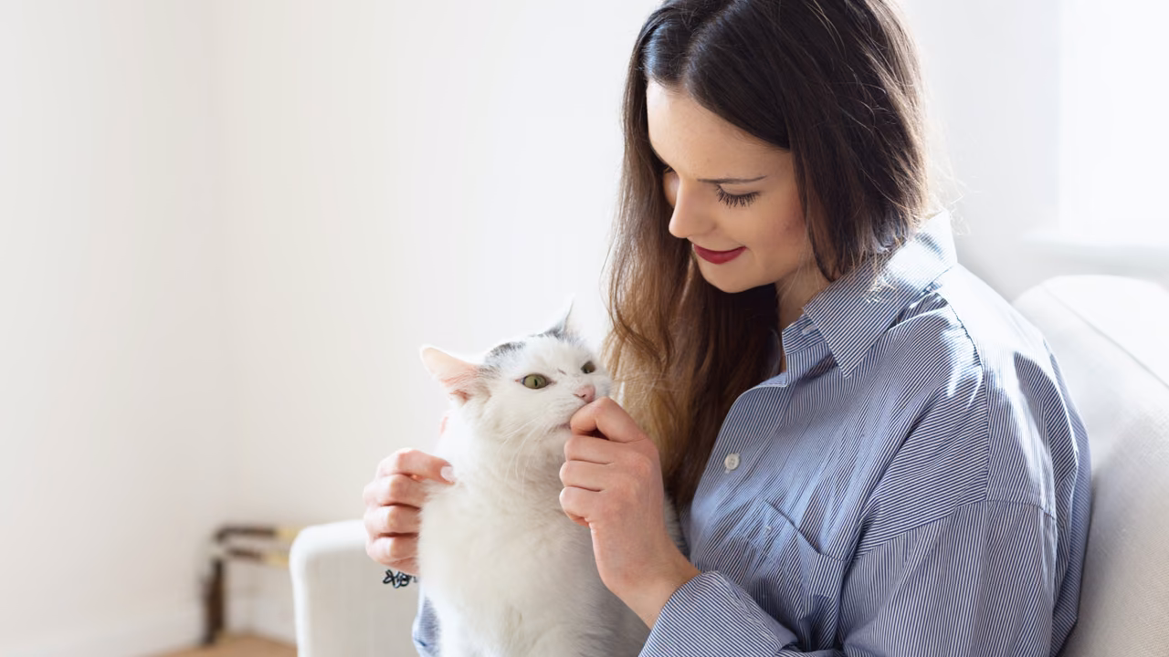 Woman cuddling her white cat at home, ESA letter in Dayton, OH