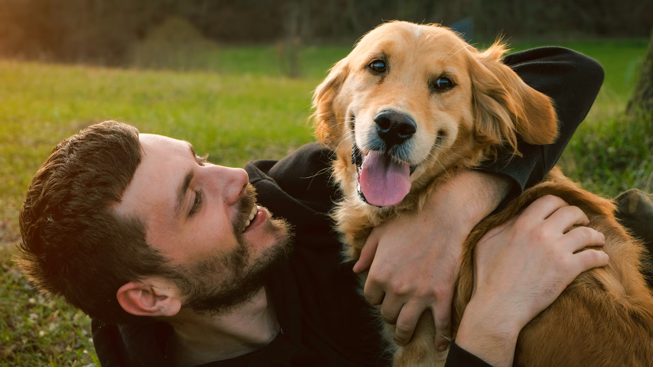 Man hugging his golden retriever outdoors, ESA letter in Fontana, CA