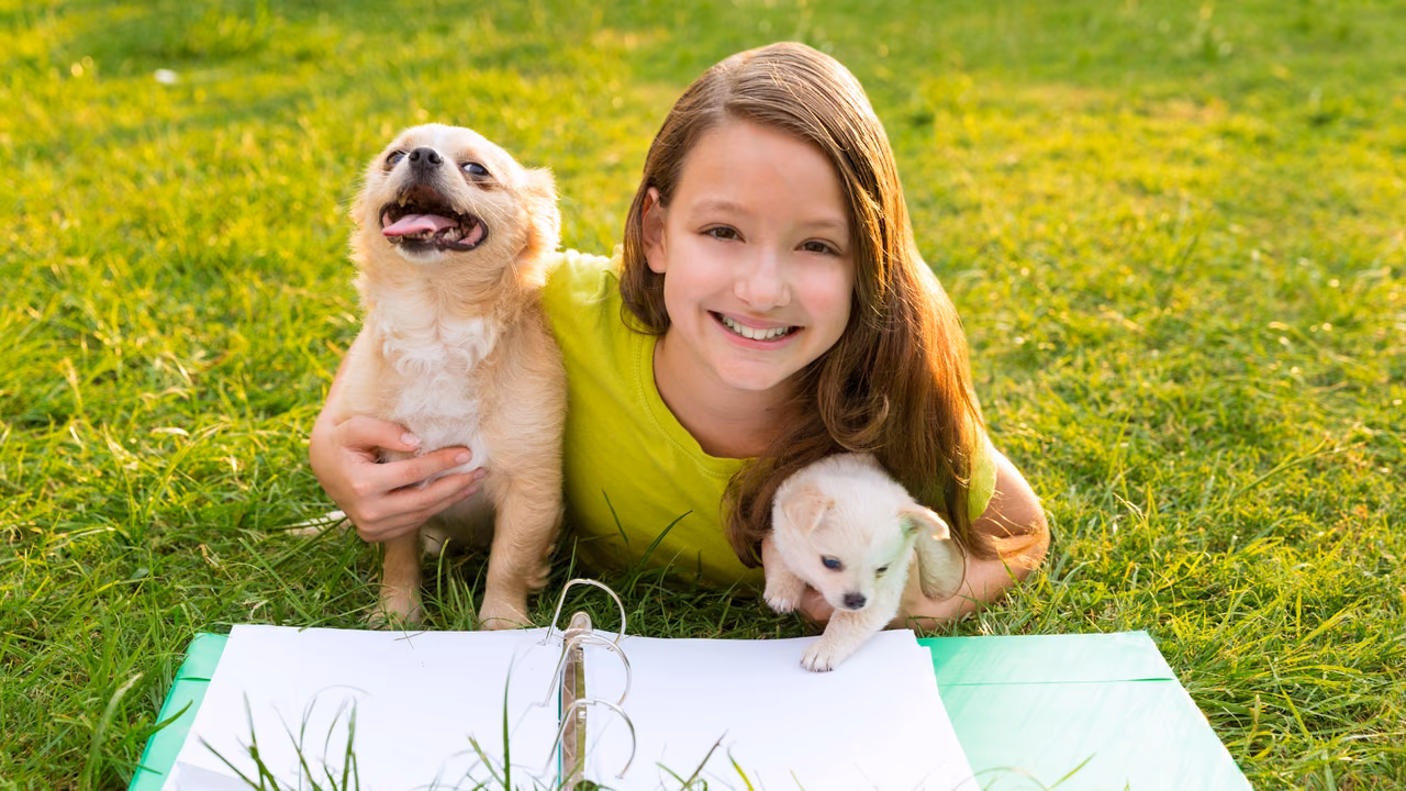 Girl lying on the grass with two small dogs, ESA letter in Glendale, CA