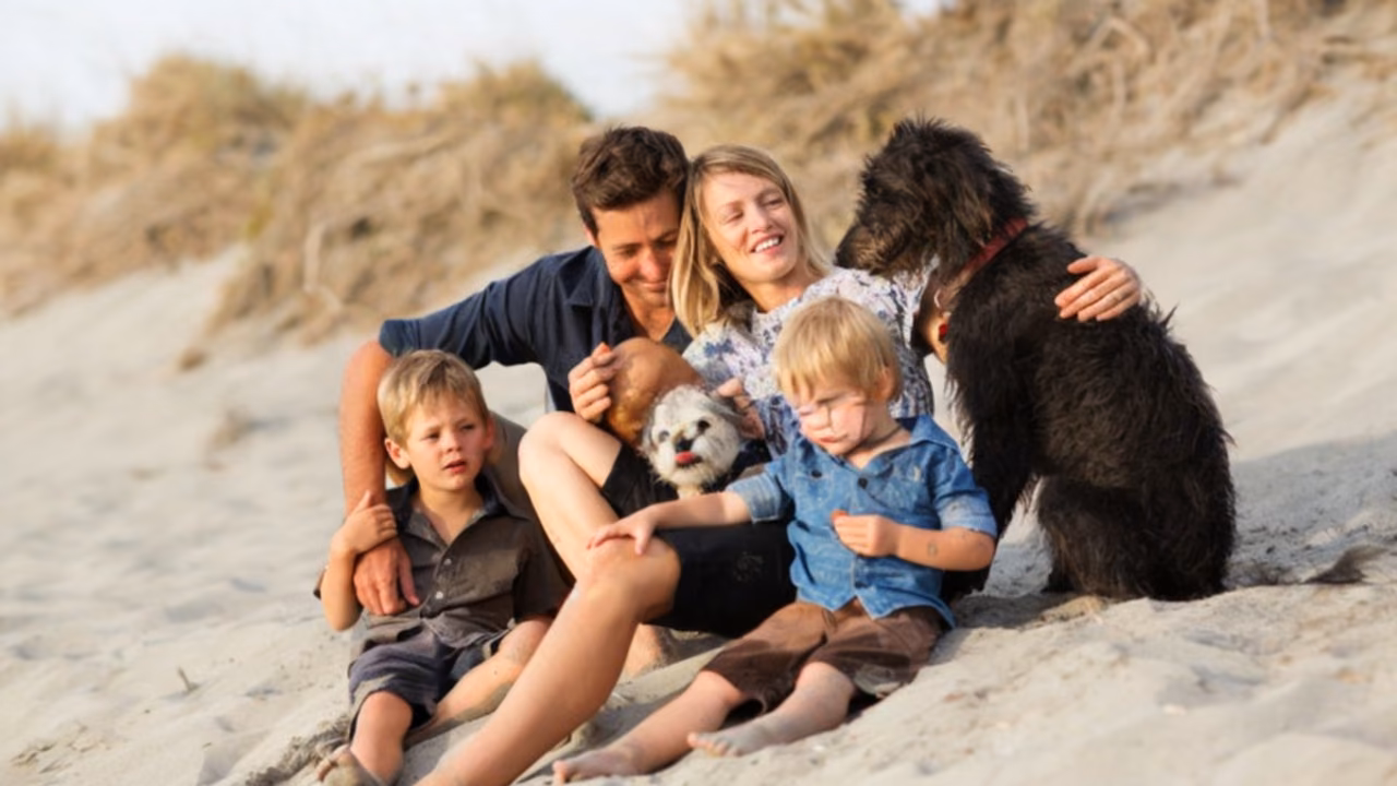 Family on a sand dune with their dogs, ESA letter in Honolulu, HI
