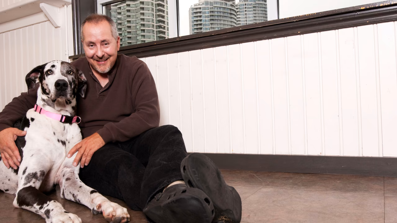 Man sitting on the floor with his Great Dane, ESA letter in Laredo, TX