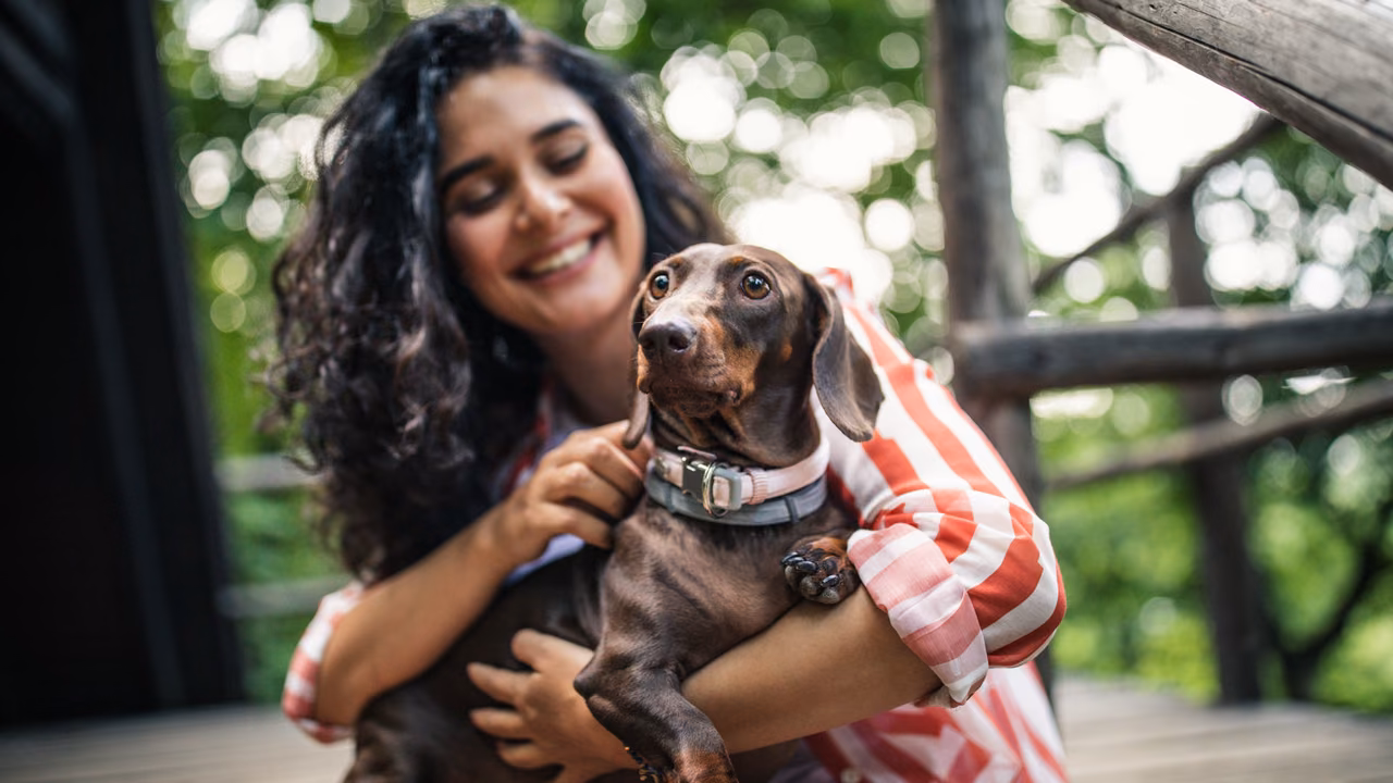 Woman hugging her dachshund outdoors, ESA letter in Mesa, AZ