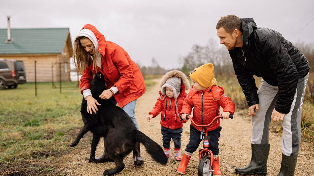 Family with young children walking their black dog on a country road, ESA letter in Montana