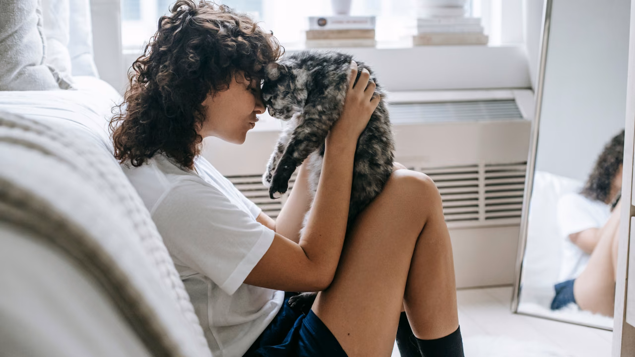 Woman holding her cat close at home, ESA letter in Nashville, TN