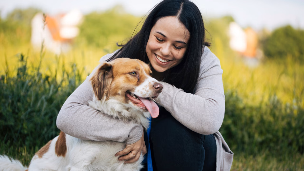 Woman hugging her dog in a sunny field, ESA letter in Philadelphia, PA