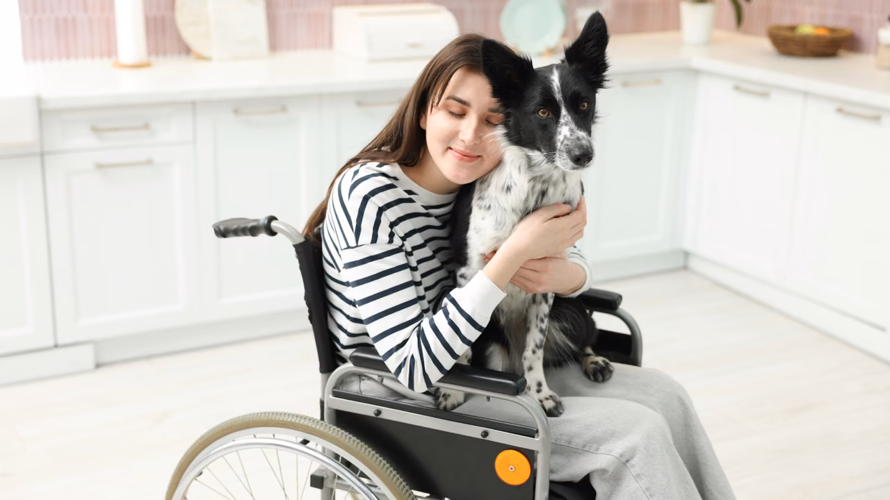Woman in a wheelchair hugging her dog in the kitchen, PSD letter in Nevada